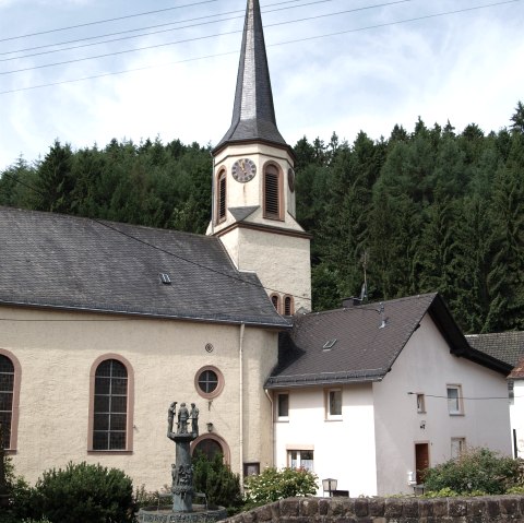 Kirche in Eisenschmitt mit Brunnen, © GesundLand Vulkaneifel GmbH Kirche in Eisenschmitt mit Brunnen, © GesundLand Vulkaneifel GmbH