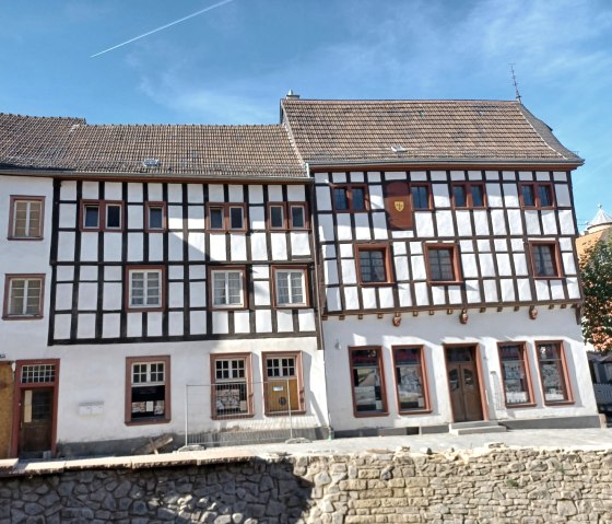 Fachwerkh&auml;user in Bad M&uuml;nstereifel mit wei&szlig;er Fassade und dunklen Balken. Blauer Himmel und ein Flugzeugstreifen im Hintergrund., &copy; Sweco GmbH