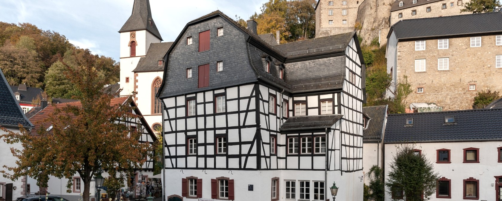 Fachwerkh&auml;user und eine Kirche pr&auml;gen den historischen Ortskern von Blankenheim. Im Hintergrund erhebt sich eine Burg auf einem H&uuml;gel., &copy; jan-ouwerkerk-gemeinde-blankenheim